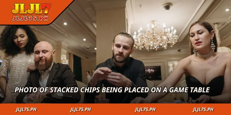 Photo of stacked chips being placed on a game table